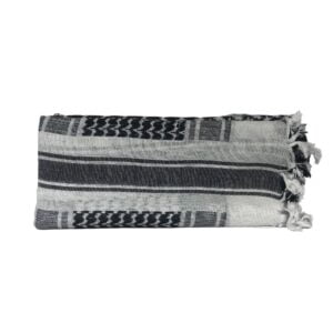 Black and white woven pillow with fringes.